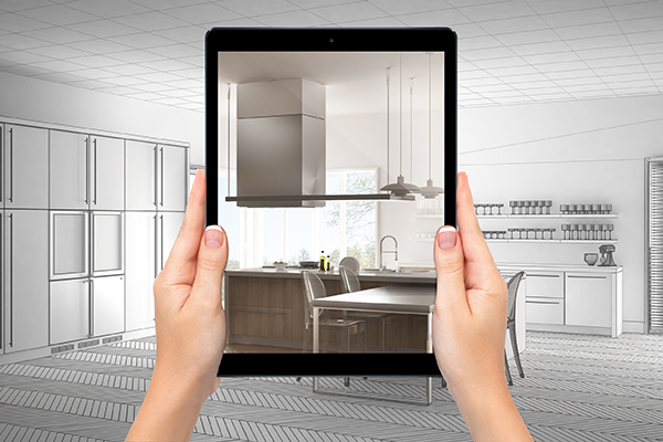 Hands holding tablet showing modern white and wooden kitchen. Blueprint CAD sketch background, augmented reality concept, application to simulate furniture and interior design product