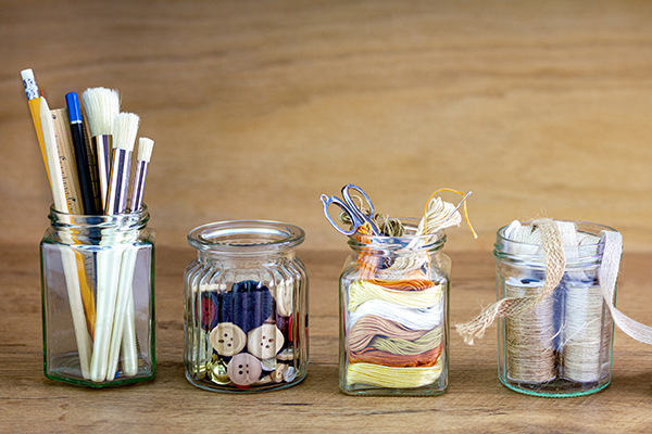 Reused jars reused for storing crafting materials, recycling at home for sustainable living, save money and zero waste