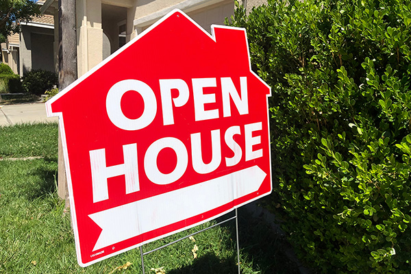 Red open house sign on front lawn.