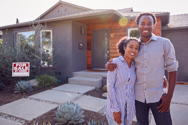 Couple outside of their home.